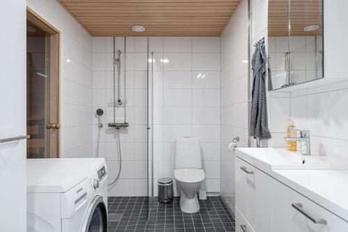 a bathroom with a toilet and a sink and a shower at Modern 1BR Apt with Amazing Views, Balcony & Sauna in Tampere