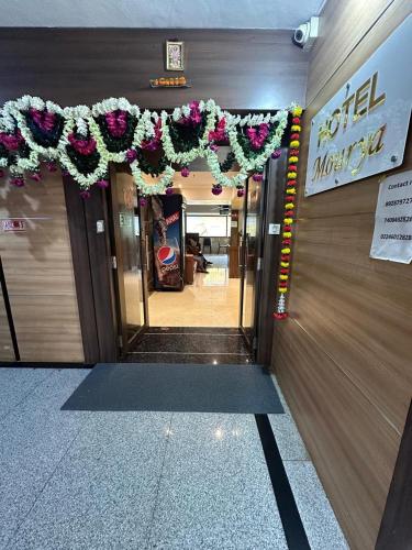 an entrance to a building with areath on the door at Hotel Mourya Residency in Navi Mumbai