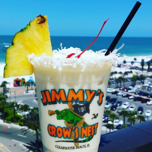 a drink with a piece of pineapple on top of the beach at Pier House 60 Clearwater Beach Marina Hotel in Clearwater Beach