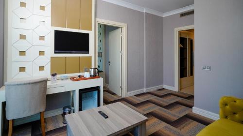 a room with a kitchen with a table and a living room at The Grand Mira Business Hotel in Istanbul
