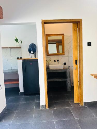 a bathroom with a sink and a mirror at Santai Retreat in Kuta Lombok