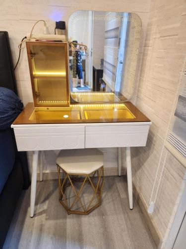 a dressing table with a mirror and a stool at Spacious 2 King Bed Family Room 56 Sqm PODOMORO APARTMENT Tower Liberty 21st Floor with Mall Direct Access in Medan