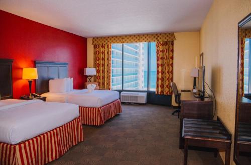 a hotel room with two beds and a window at Pier House 60 Clearwater Beach Marina Hotel in Clearwater Beach