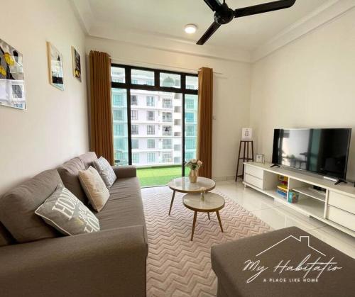 a living room with a couch and a flat screen tv at Platino 13 Pax, Mins away from Paradigm & Legoland in Johor Bahru