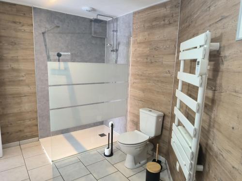 a bathroom with a toilet and a shower at Les Champs De La Mer in Auberville-la-Renault