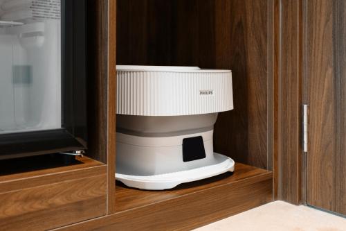 a white food processor in a wooden cabinet at Fortune Land Shenzhen in Shenzhen