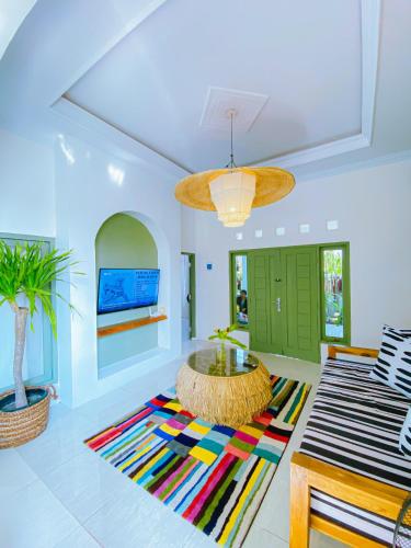 a living room with a table and a rug at Villa Ganesh by Suasana Villa in Jarakan