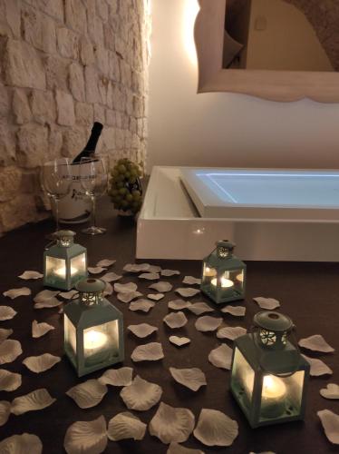 a room with a bed and a bunch of rocks on the floor at Piervì Suite in Putignano
