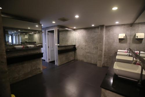 a bathroom with a sink and a mirror at Here We Go Bangkok in Bangkok