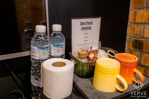 a counter with two bottles of water and a roll of toilet paper at Ipoh The Label by Verve in Kampong Simee