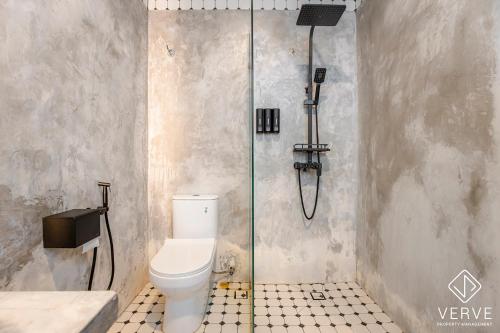 a shower stall with a toilet in a bathroom at Ipoh The Label by Verve in Kampong Simee