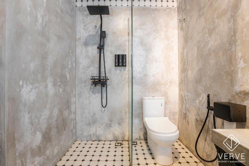 a shower stall with a toilet in a bathroom at Ipoh The Label by Verve in Kampong Simee