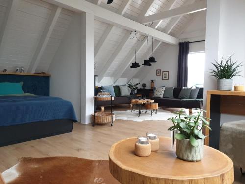 una sala de estar con una cama y una mesa en Ferienhof Elbauenblick, en Radebeul