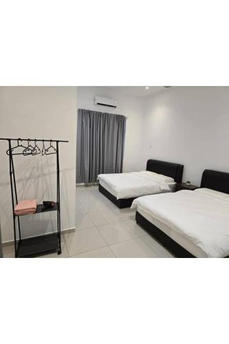 a hotel room with two beds and a table at J Garden Village in Muar