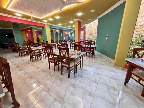 a dining room with wooden tables and chairs at Reef House in Marsa Alam City