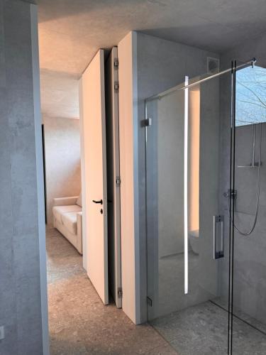 a bathroom with a shower with a glass door at The Box in Sint-Pieters-Leeuw