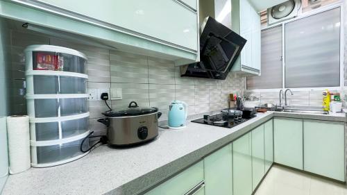 a kitchen with a stove and a pot on a counter at IPOH Sky Garden Residences, 31200 Chemor Ipoh in Chemor