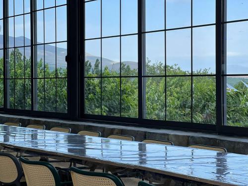 a conference room with tables and chairs in front of windows at Cherry House Ohanavan by Amaranoc am in Oganavan