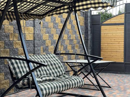a chair sitting under an umbrella on a patio at Cherry House Ohanavan by Amaranoc am in Oganavan