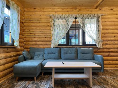 a living room with a blue couch and a table at Cherry House Ohanavan by Amaranoc am in Oganavan