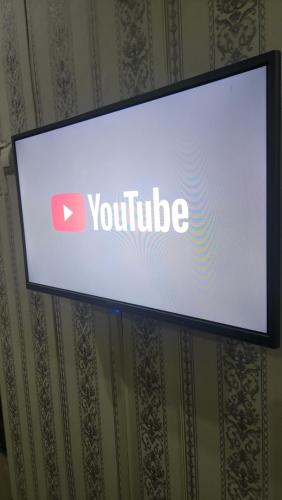 a screen with a youtube sign on a wall at Mini Studio Meublé venez loger ici in Dakar