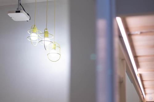 a row of lights hanging from a ceiling at Rest Chinatown Hotel in Singapore
