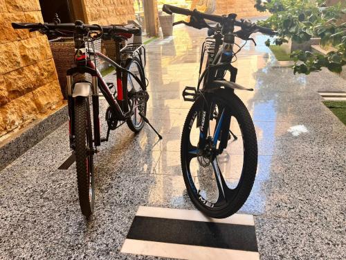 two bikes parked on a sidewalk in the rain at Reef House in Marsa Alam City