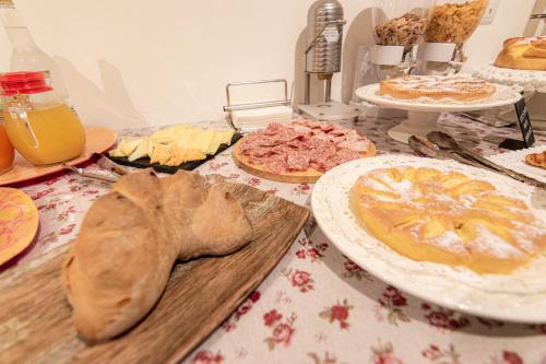 a table topped with plates of food and pies at Profumi di Primavera Luxury Rooms & Suite in Matera
