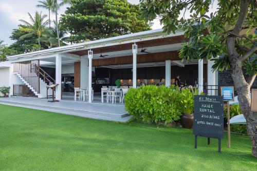 a restaurant with a sign in front of a building at KC Beach Club & Pool Villas in Chaweng