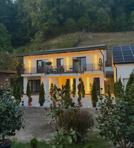 a house with solar panels on the side of it at Hotel Casa Blanca in Tulgheş