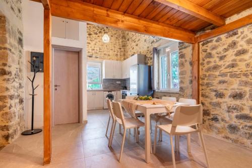 a kitchen and dining room with a table and chairs at Villa Emilia in Ayía Varvára