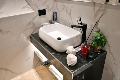 a bathroom with a white sink on a counter at Domus De Cinti Boutique Rooms in Tivoli