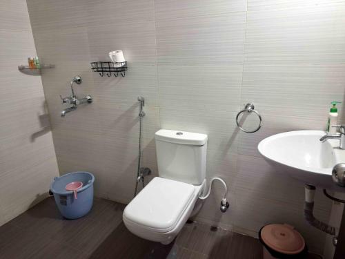 a bathroom with a toilet and a sink at Sublime Homestay in Bhubaneshwar