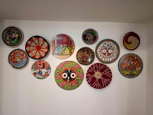 a group of plates hanging on a wall at Sublime Homestay in Bhubaneshwar