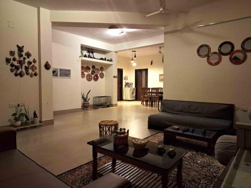 a living room with a couch and a table at Sublime Homestay in Bhubaneshwar