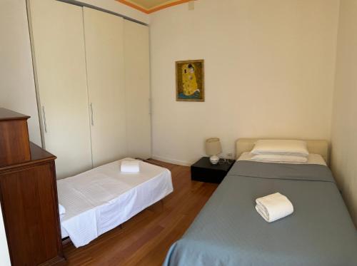 a small room with two beds and a cabinet at Pang's Home in Marghera