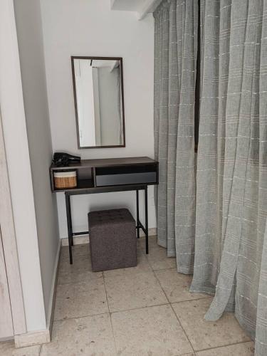 a mirror and a piano in a room at Marina view seaside apartment in Larnaka