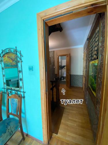 a doorway into a room with a blue wall at Cottage Kazka Lisu in Skhidnitsa