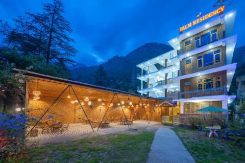 a hotel in the mountains at night at Palm Residency, Kasol in Kasol