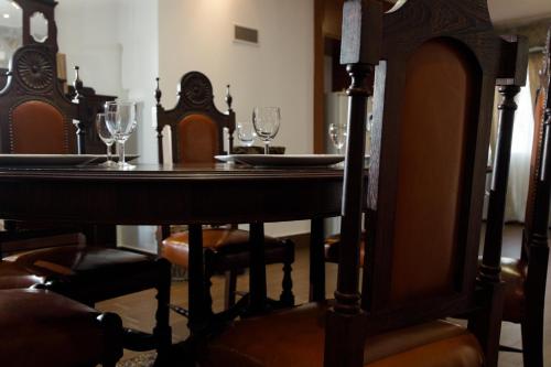 a dining room table with wine glasses on it at Casa dos Chuchos in Cabanas de Viriato