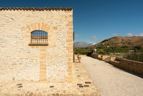 a brick building with a window on the side of it at Tenute Baglio Passofondo in Alcamo