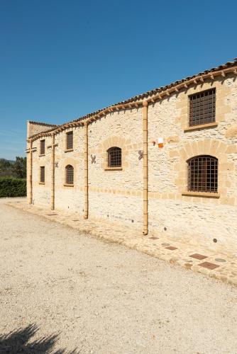 a brick building with windows on the side of it at Tenute Baglio Passofondo in Alcamo