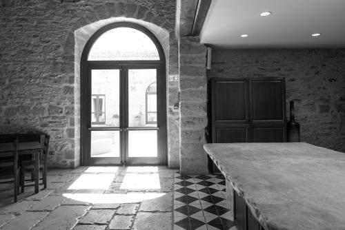 a room with a table and a large window at Tenute Baglio Passofondo in Alcamo