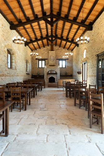 a large room with wooden tables and chairs at Tenute Baglio Passofondo in Alcamo