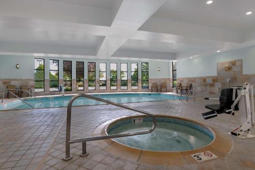 a swimming pool with a hot tub in a building at Hampton Inn & Suites Billings West I-90 in Billings