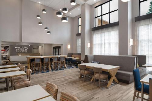 a restaurant with tables and chairs and a waiting room at Hampton Inn & Suites Billings West I-90 in Billings
