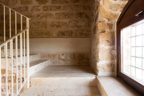 a staircase in a brick building with a window at Tenute Baglio Passofondo in Alcamo