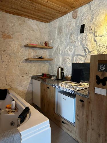a kitchen with a stove and a counter top at Kandybos Eco Farm Village in Kas