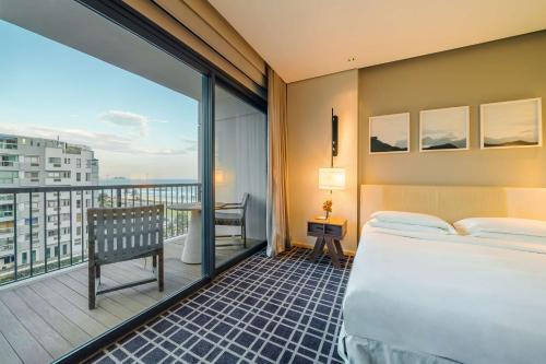 a hotel room with a bed and a balcony at Grand Hyatt Rio de Janeiro in Rio de Janeiro