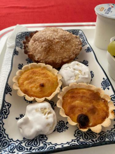 a blue and white plate with three desserts on it at B&B Su Canistreddu in Alghero
